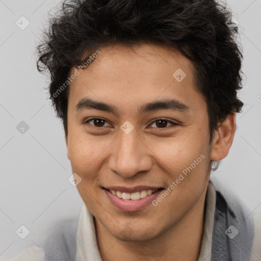 Joyful latino young-adult male with short  brown hair and brown eyes