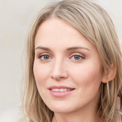 Joyful white young-adult female with long  brown hair and blue eyes