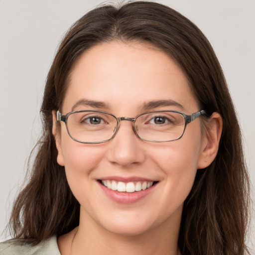 Joyful white young-adult female with long  brown hair and grey eyes