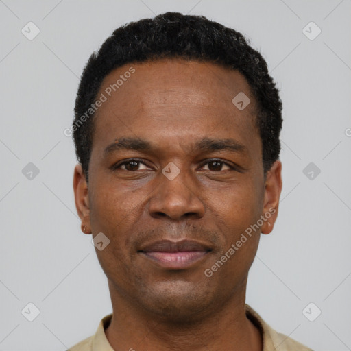 Joyful black young-adult male with short  black hair and brown eyes