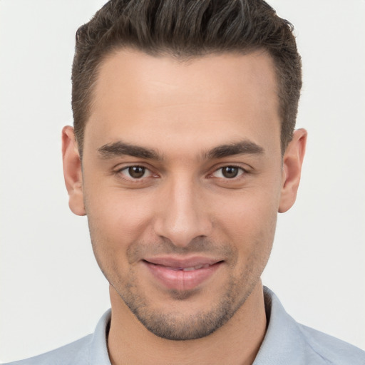 Joyful white young-adult male with short  brown hair and brown eyes