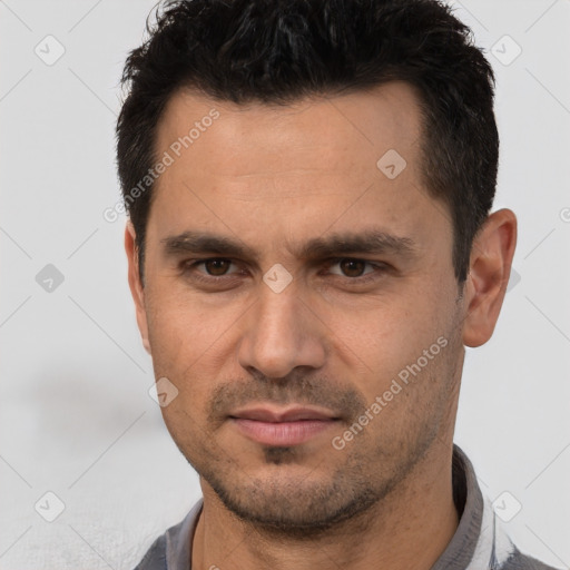 Joyful white young-adult male with short  black hair and brown eyes