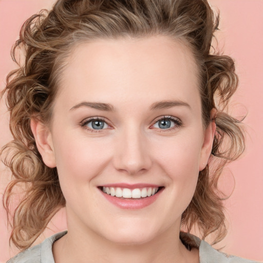 Joyful white young-adult female with medium  brown hair and blue eyes