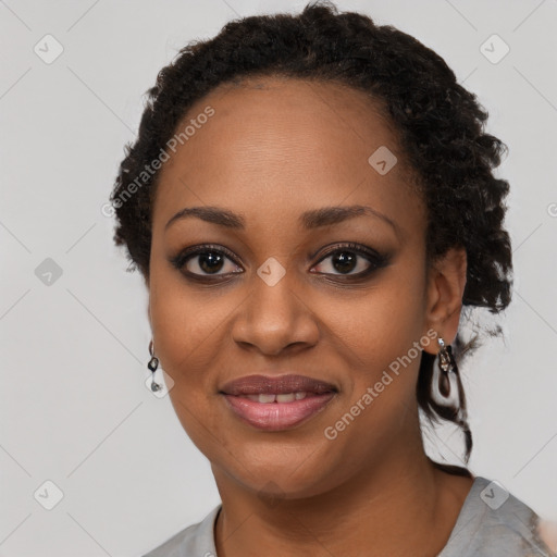 Joyful black young-adult female with short  black hair and brown eyes