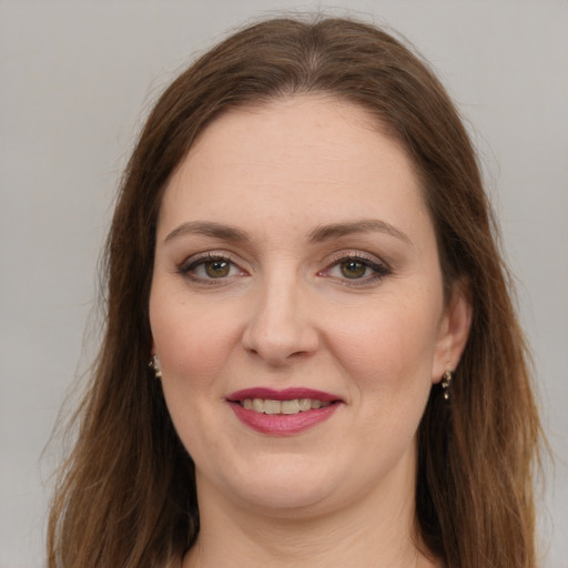 Joyful white young-adult female with long  brown hair and green eyes