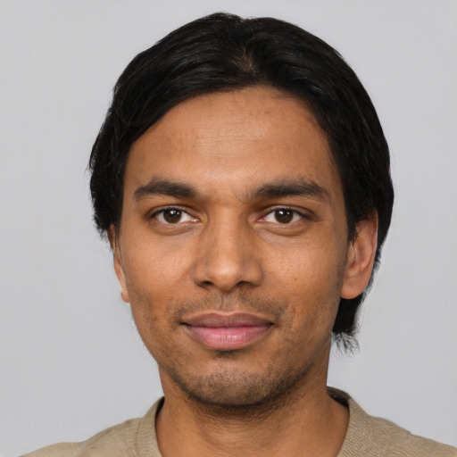 Joyful black young-adult male with short  black hair and brown eyes