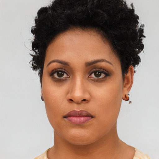 Joyful latino young-adult female with short  brown hair and brown eyes