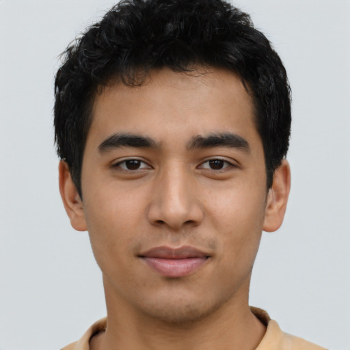 Joyful latino young-adult male with short  brown hair and brown eyes