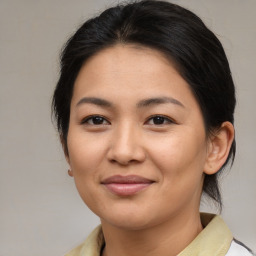 Joyful asian young-adult female with medium  brown hair and brown eyes