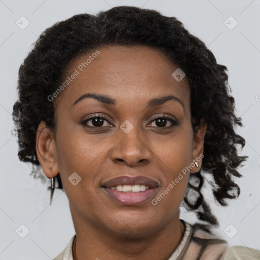 Joyful black adult female with short  brown hair and brown eyes