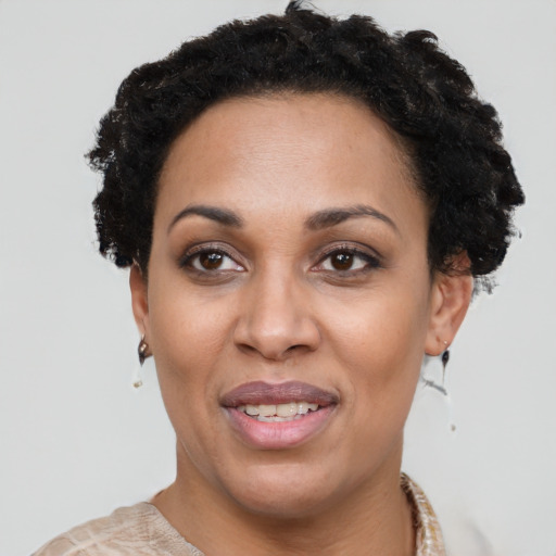 Joyful black adult female with short  black hair and brown eyes