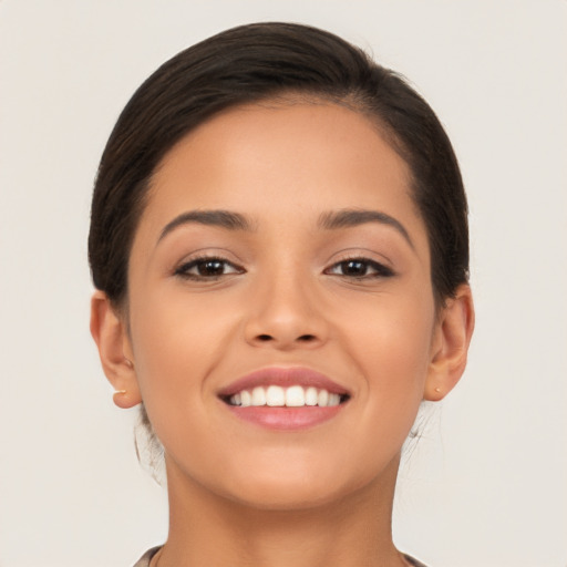 Joyful latino young-adult female with short  brown hair and brown eyes