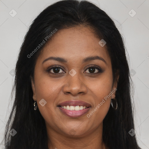 Joyful black young-adult female with long  brown hair and brown eyes