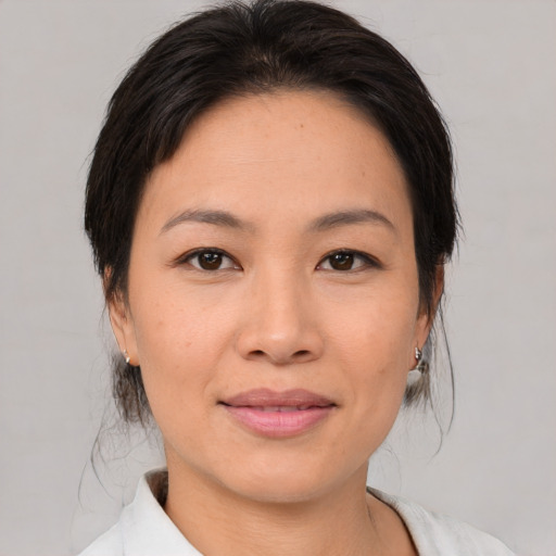 Joyful asian young-adult female with medium  brown hair and brown eyes