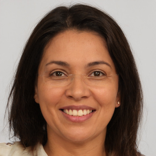 Joyful white adult female with medium  brown hair and brown eyes