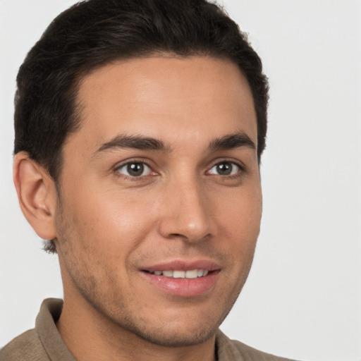 Joyful white young-adult male with short  brown hair and brown eyes