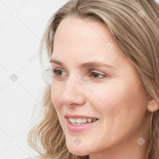 Joyful white young-adult female with long  brown hair and blue eyes