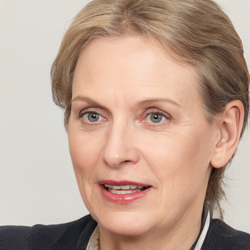 Joyful white adult female with medium  brown hair and blue eyes