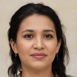 Joyful latino young-adult female with medium  brown hair and brown eyes