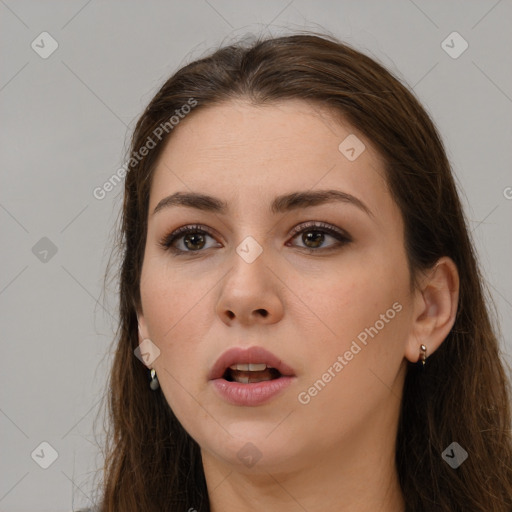 Neutral white young-adult female with long  brown hair and brown eyes