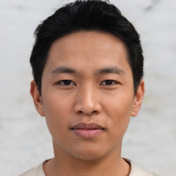 Joyful asian young-adult male with short  black hair and brown eyes