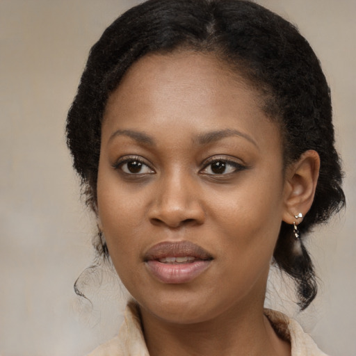 Joyful black adult female with medium  brown hair and brown eyes
