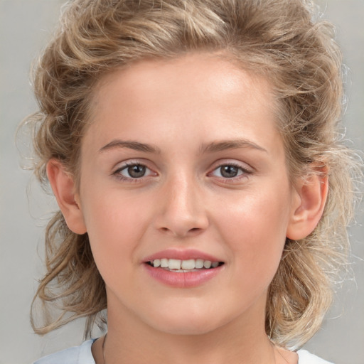 Joyful white child female with medium  brown hair and brown eyes