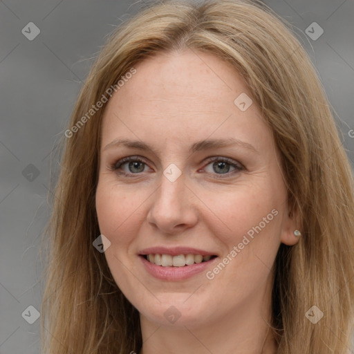 Joyful white adult female with long  brown hair and brown eyes