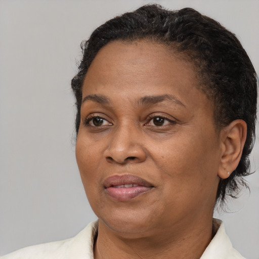 Joyful black adult female with short  brown hair and brown eyes