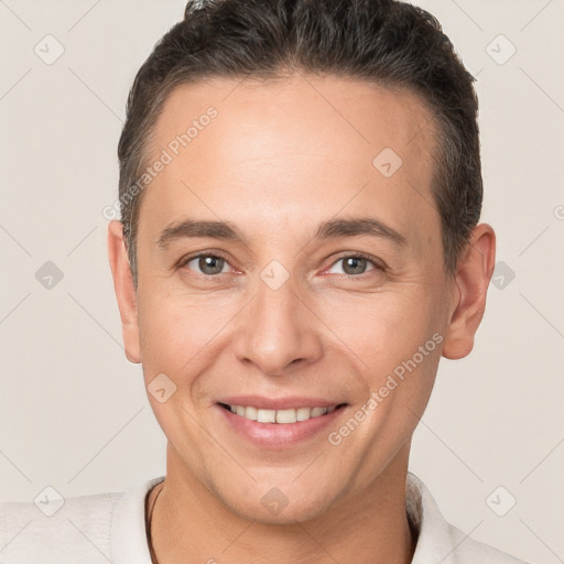 Joyful white adult male with short  brown hair and brown eyes