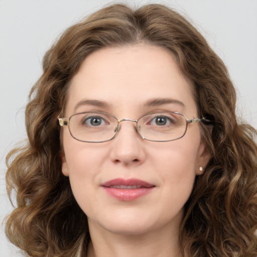 Joyful white adult female with long  brown hair and green eyes