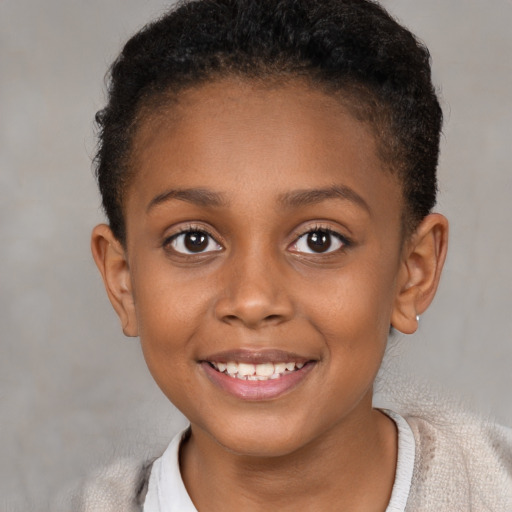 Joyful black child female with short  brown hair and brown eyes