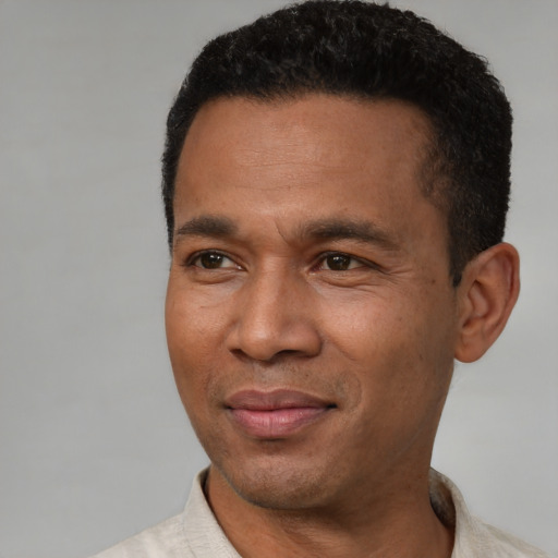 Joyful latino adult male with short  black hair and brown eyes