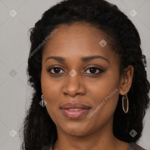 Joyful black young-adult female with long  brown hair and brown eyes