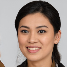 Joyful asian young-adult female with medium  brown hair and brown eyes