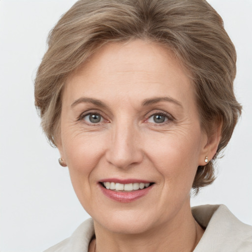 Joyful white adult female with medium  brown hair and grey eyes