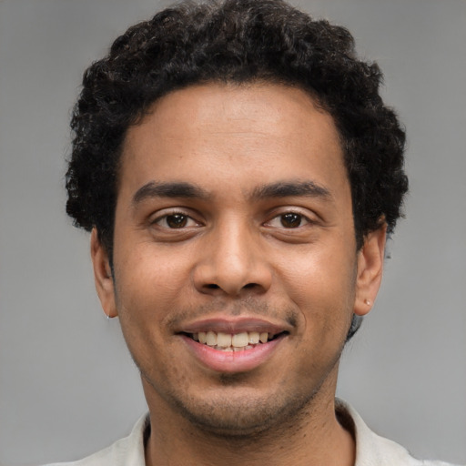 Joyful white young-adult male with short  black hair and brown eyes