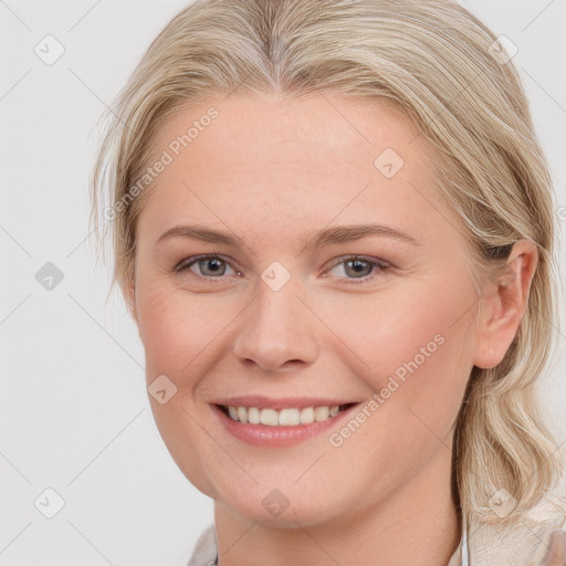 Joyful white young-adult female with medium  brown hair and blue eyes