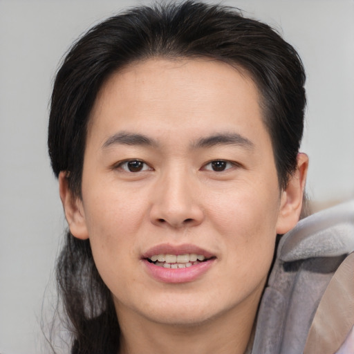 Joyful asian young-adult male with medium  brown hair and brown eyes