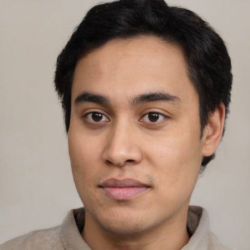 Joyful asian young-adult male with short  black hair and brown eyes