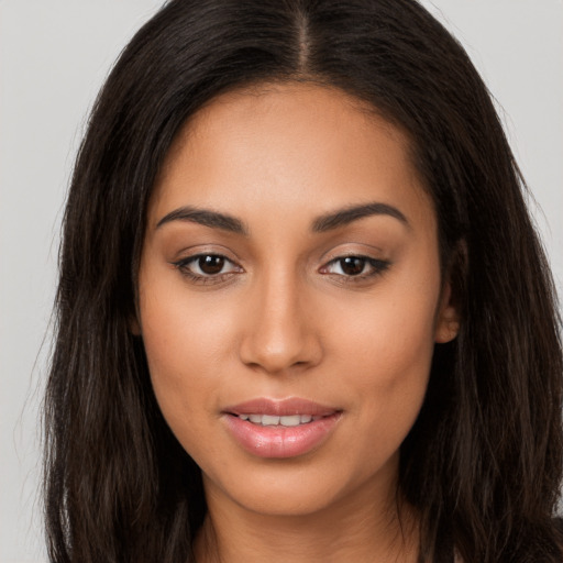 Joyful latino young-adult female with long  brown hair and brown eyes