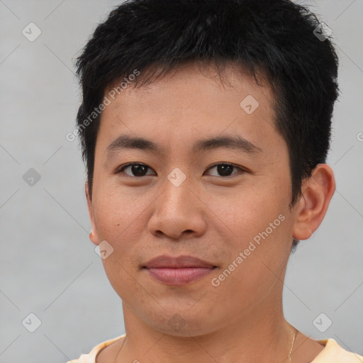 Joyful asian young-adult male with short  brown hair and brown eyes