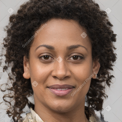 Joyful black adult female with medium  brown hair and brown eyes