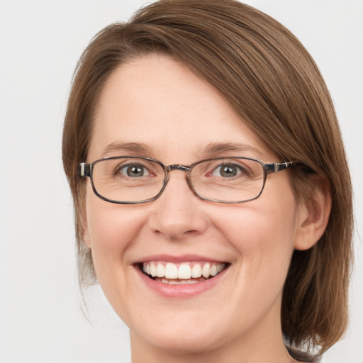 Joyful white adult female with medium  brown hair and blue eyes