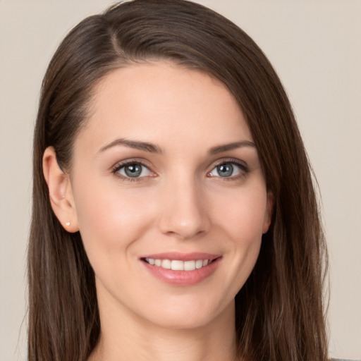 Joyful white young-adult female with long  brown hair and grey eyes