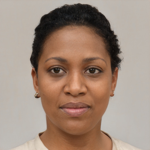 Joyful black young-adult female with short  brown hair and brown eyes