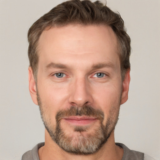 Joyful white adult male with short  brown hair and grey eyes