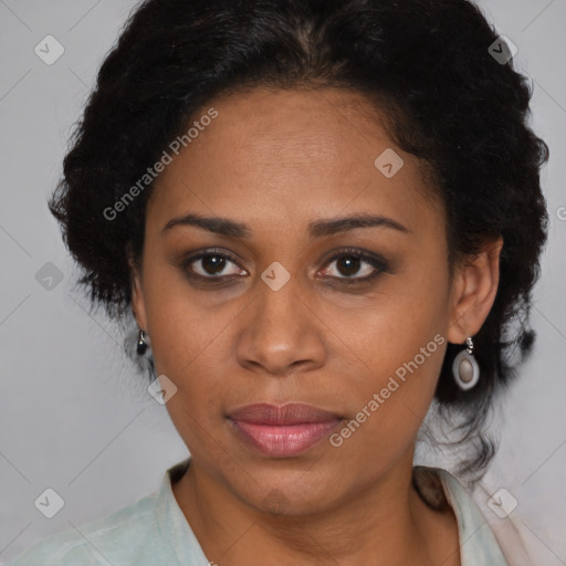 Joyful black adult female with medium  brown hair and brown eyes