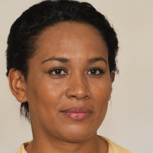 Joyful black adult female with short  brown hair and brown eyes
