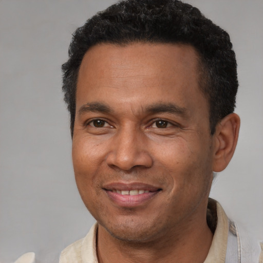 Joyful latino adult male with short  brown hair and brown eyes